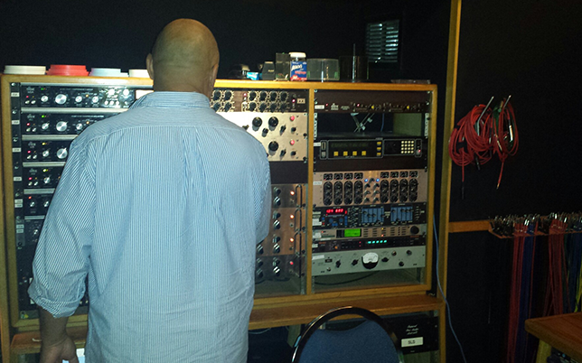 Recording Engineer Ralph Sutton adjusting analog outboard equipment