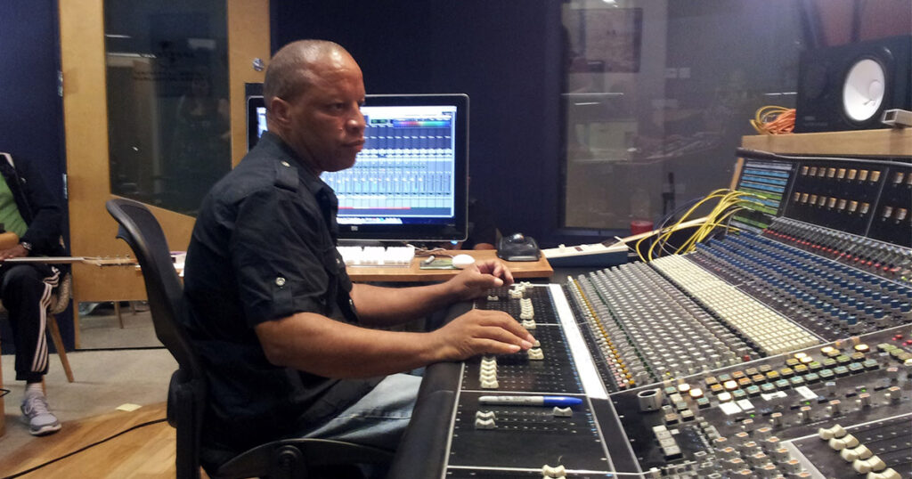 Picture of Recording Engineer Ralph Sutton doing a recording session using an API recording console